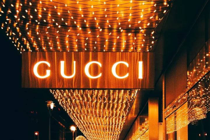 Gucci logo at night symbolizing the fading allure of modern luxury.