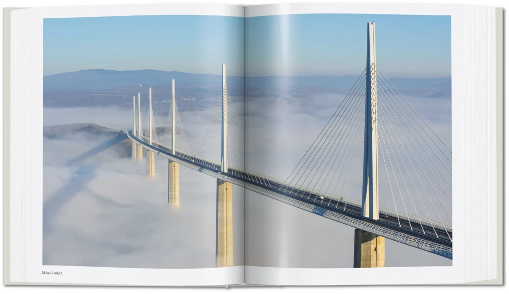 Aerial view of the Millau Viaduct by Norman Foster emerging above clouds in southern France.